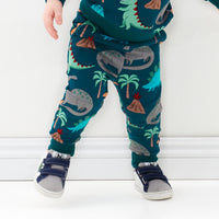 Close up image of a child wearing Teal Prehistoric Pals joggers