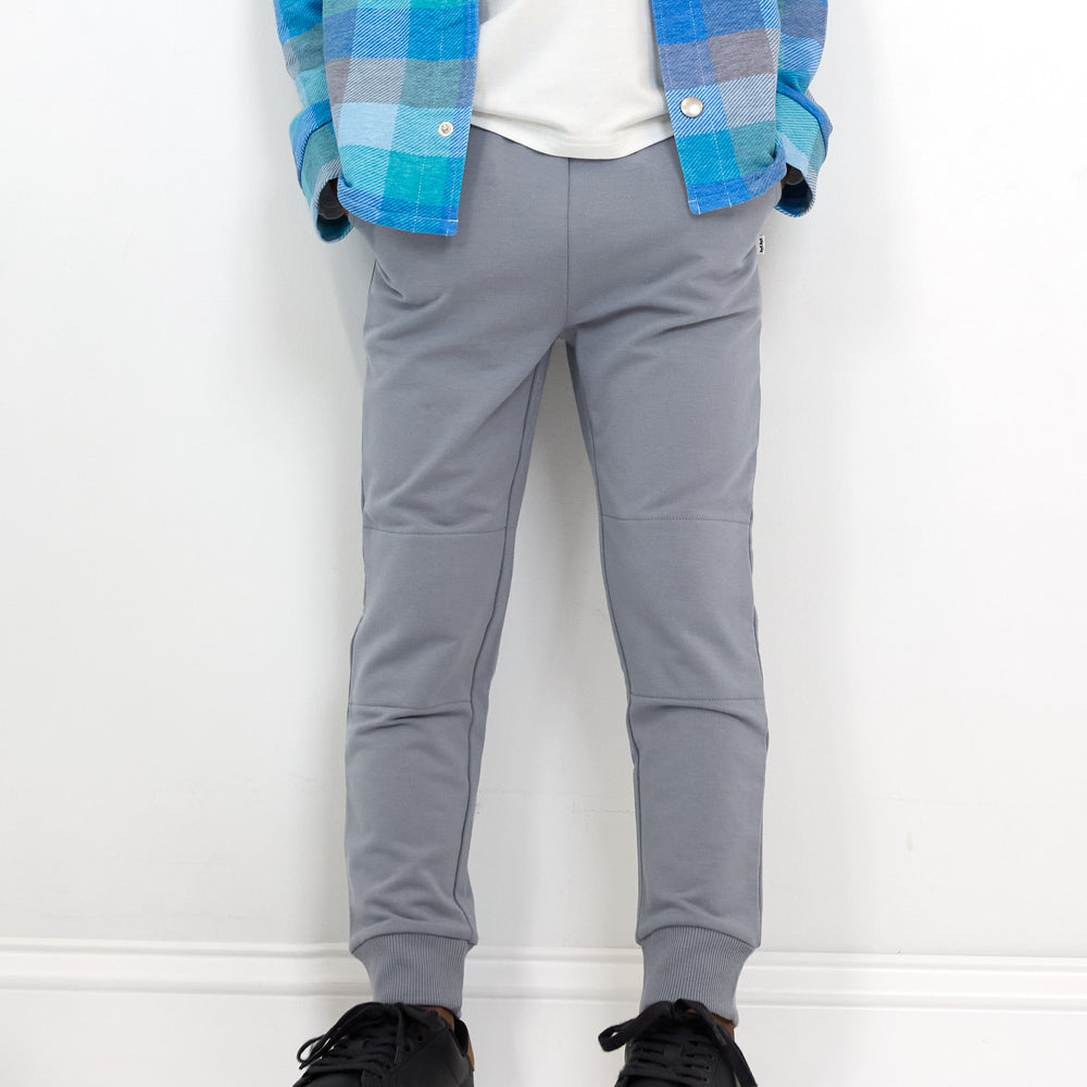 Close up image of boy wearing the Windy Sky Jogger and Arctic Plaid Shacket