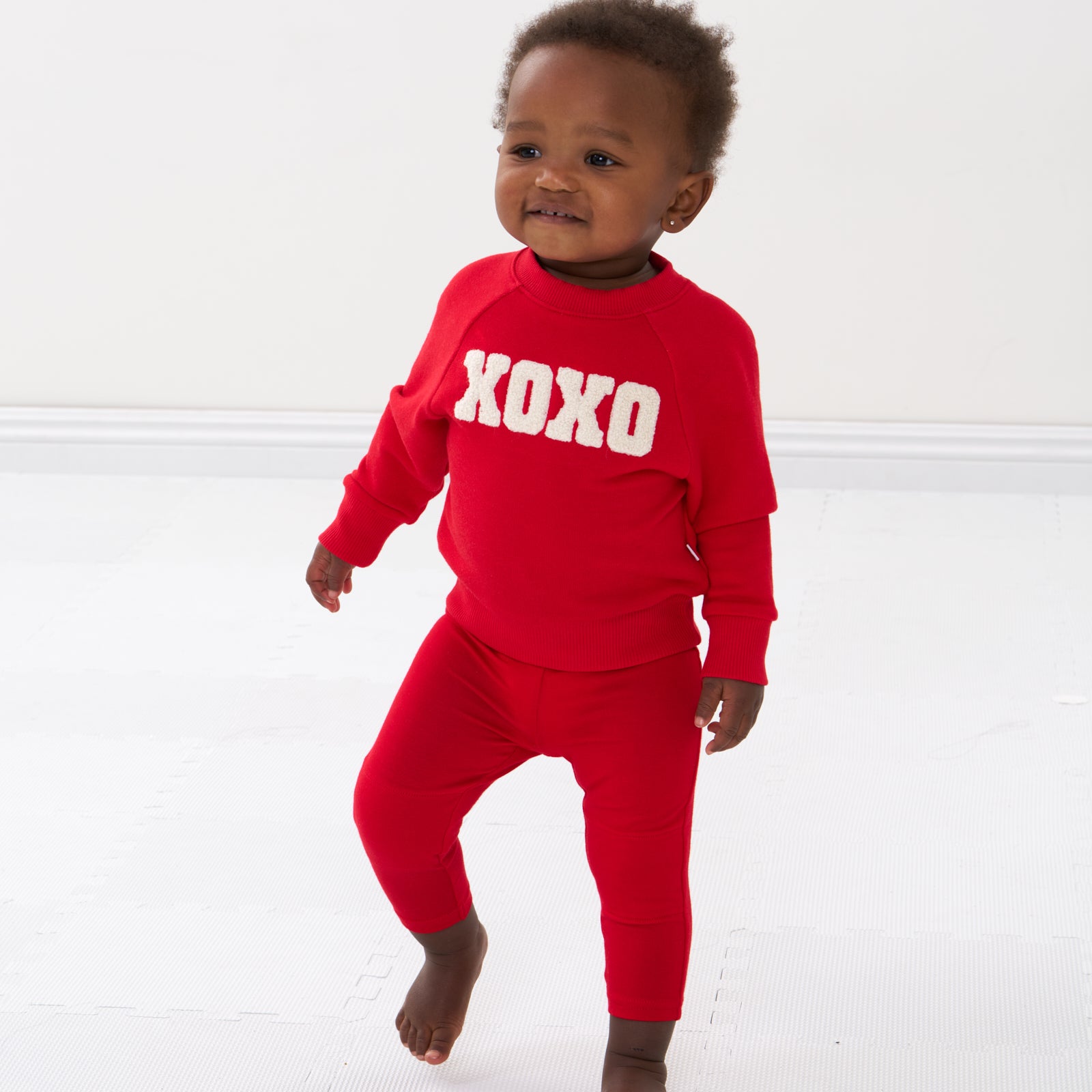 Child wearing Candy Red leggings and matching crewneck sweatshirt