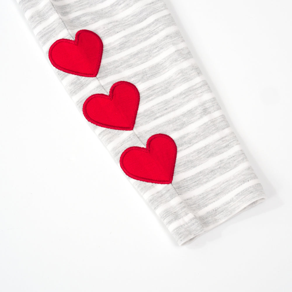 close up view of the embroidered patches on a heart patch legging