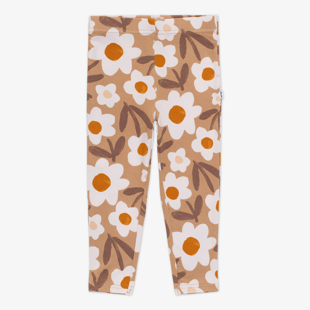 Flat lay of a Daisy Daydream legging featuring a tan floral design