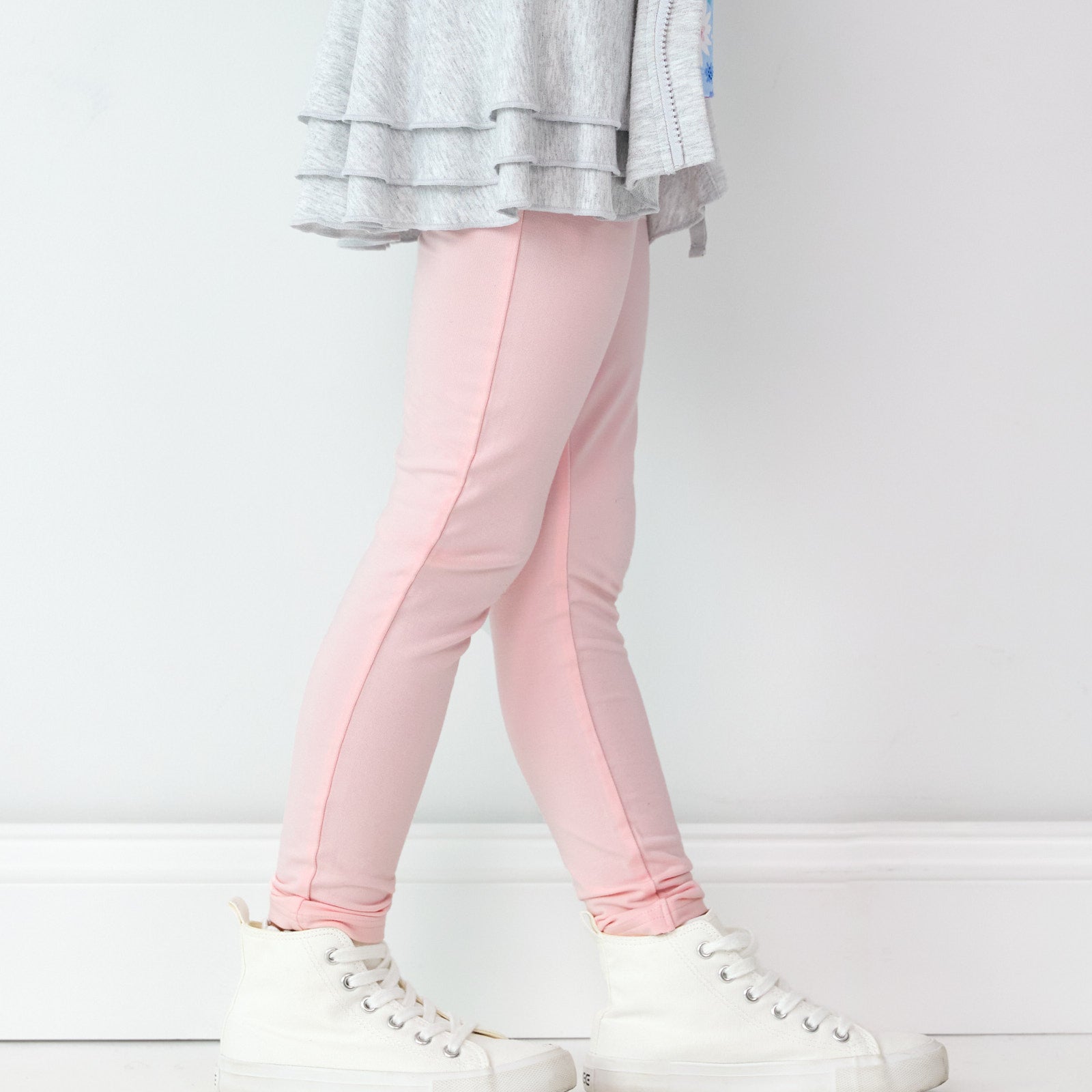 Close up side view image of child wearing the Prima Pink Legging