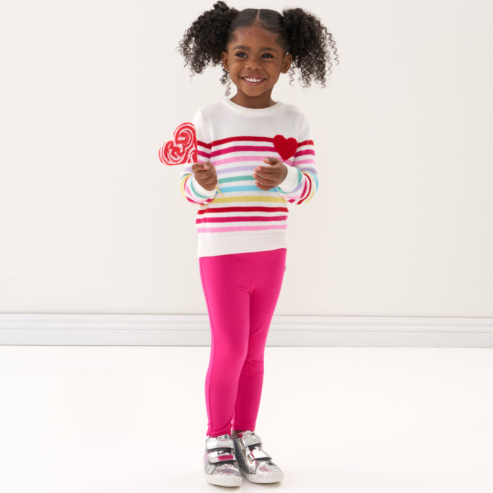 Click to see full screen - Child wearing Pink Punch leggings and a coordinating knit sweater