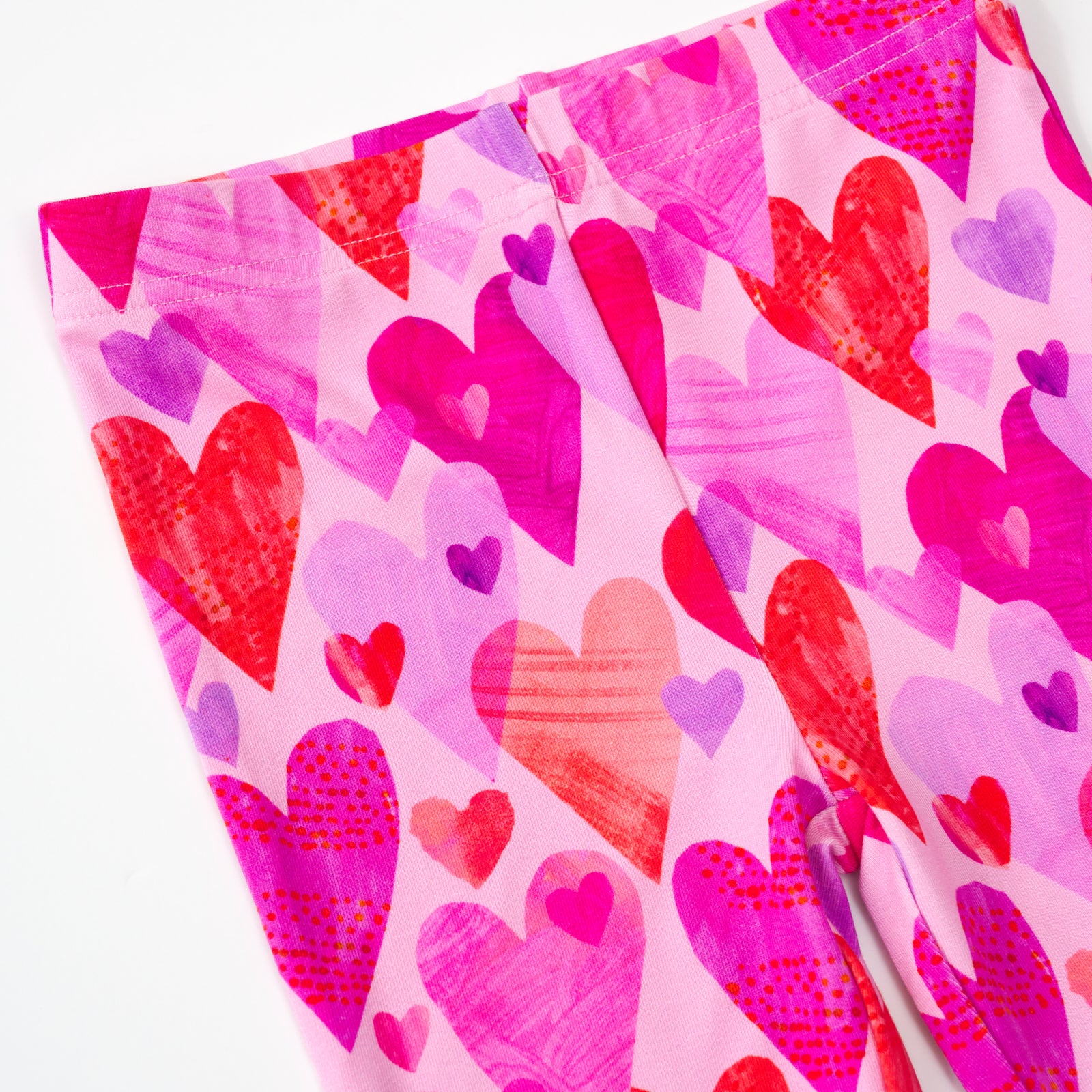 close up flat lay of a pink hearts & crafts legging