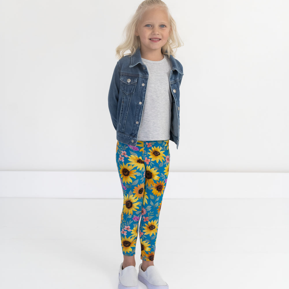 Image of a child wearing Sunflower Fields Leggings, Light Heather Gray Puff Sleeve Tee, and Midwash Blue Denim Trucker Jacket