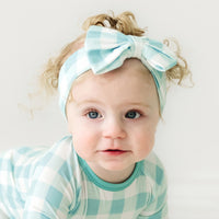 Alternate close up image of a child wearing an Aqua Gingham luxe bow headband
