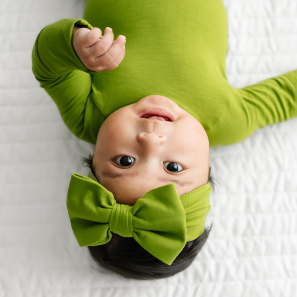 Alternate close up image of a child wearing an Avocado luxe bow headband