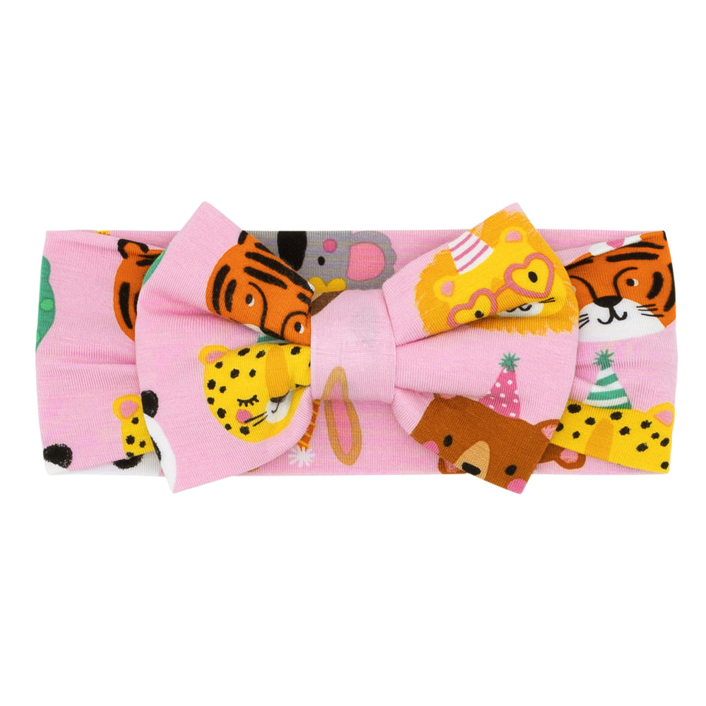 Flat lay image of a Pink Party Pals luxe bow headband