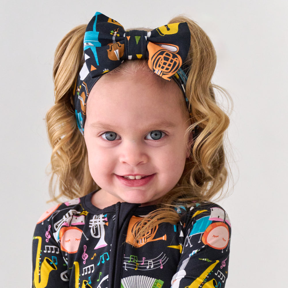 Child wearing a Keys and Chords luxe bow headband and matching pajamas