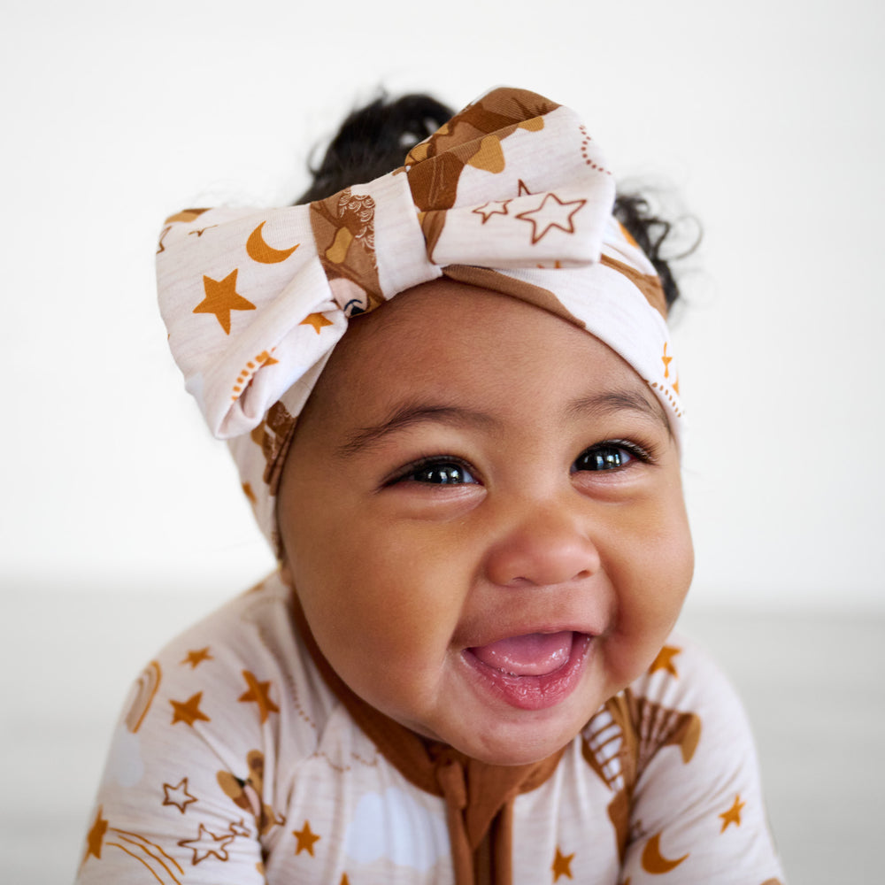 baby laughing wearing beary sleepy luxe bow headband