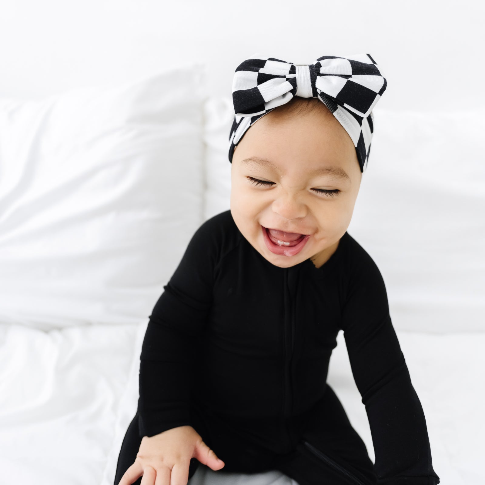 child wearing a Cool Checks luxe bow headband and black zippy