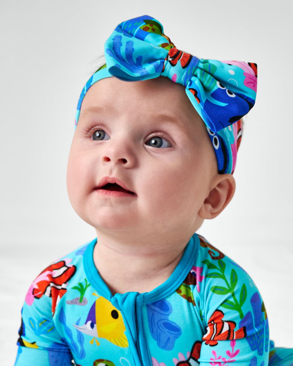 Close up of child wearing the Disney Nemo's Reef Luxe Bow Headband