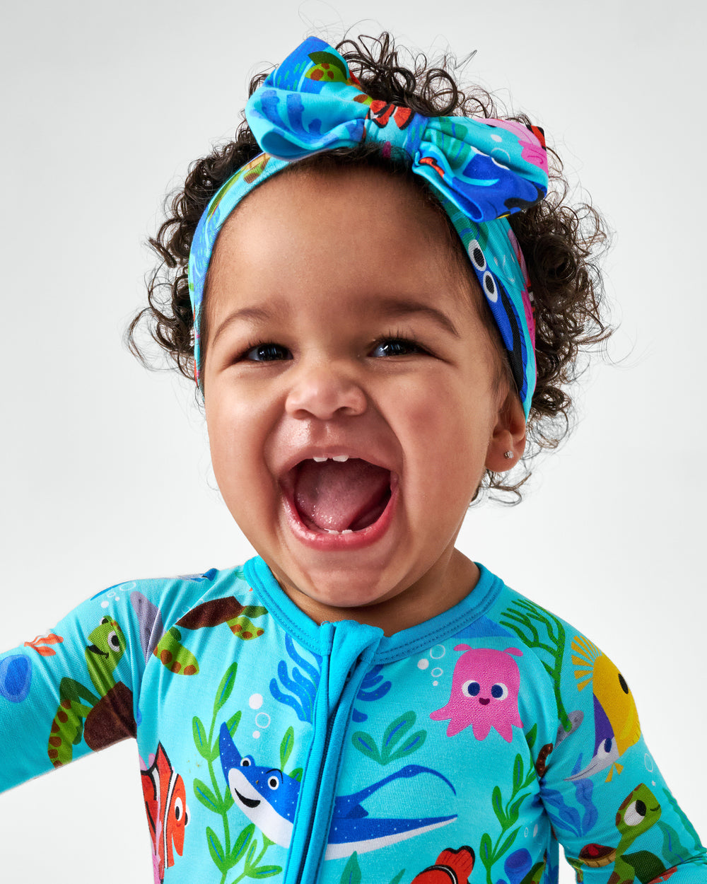 Alternate child wearing the Disney Nemo's Reef Luxe Bow Headband and matching bamboo zippy
