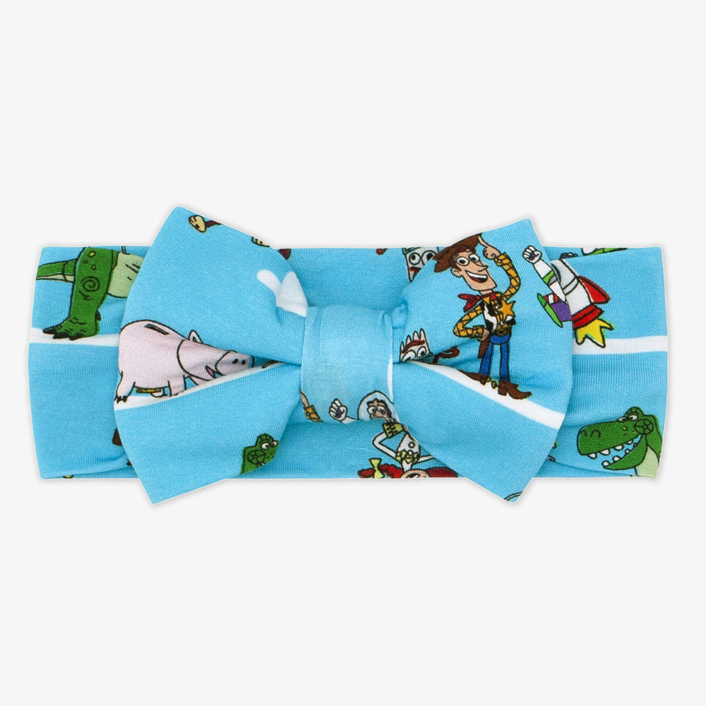 Flat lay image of a Disney Pixar Toy Story Pals luxe bow headband in size newborn to 3T