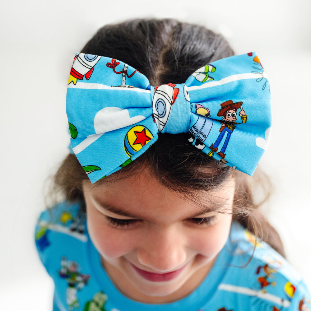 Close up image of a child wearing a Luxe Bow Headband