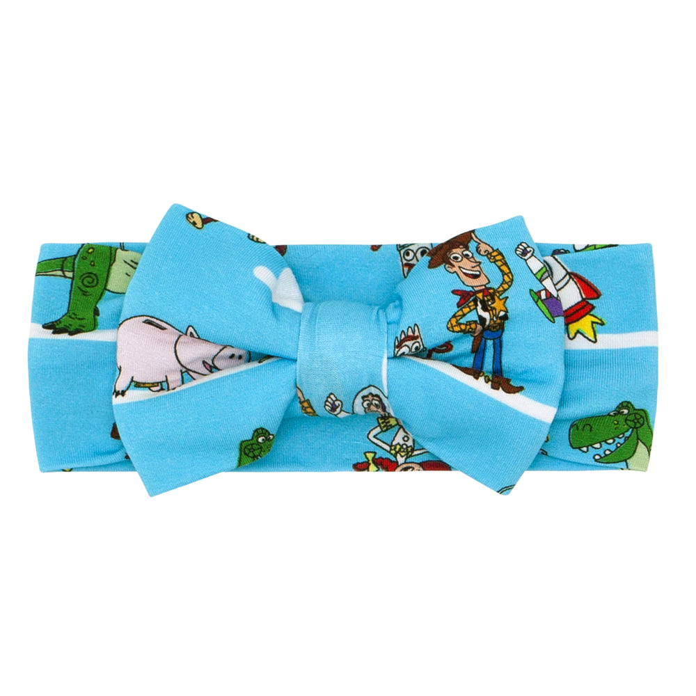 Click to see full screen - Flat lay image of a Disney Pixar Toy Story Pals luxe bow headband
