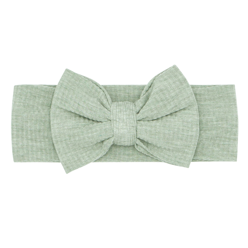 Flat lay image of a Heather Sage ribbed luxe bow headband