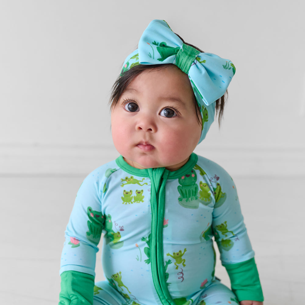 Child wearing a Leaping Love luxe bow headband and matching zippy
