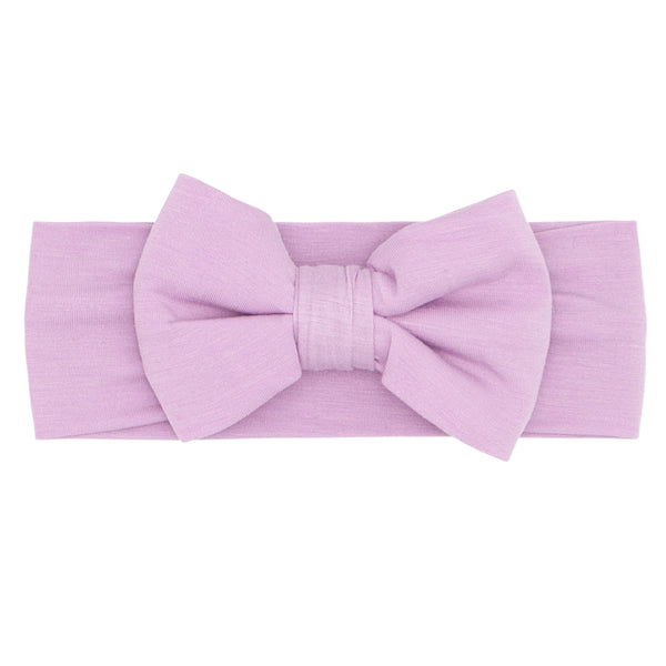 Flat lay image of a Light Orchid luxe bow headband