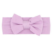 Flat lay image of a Light Orchid luxe bow headband