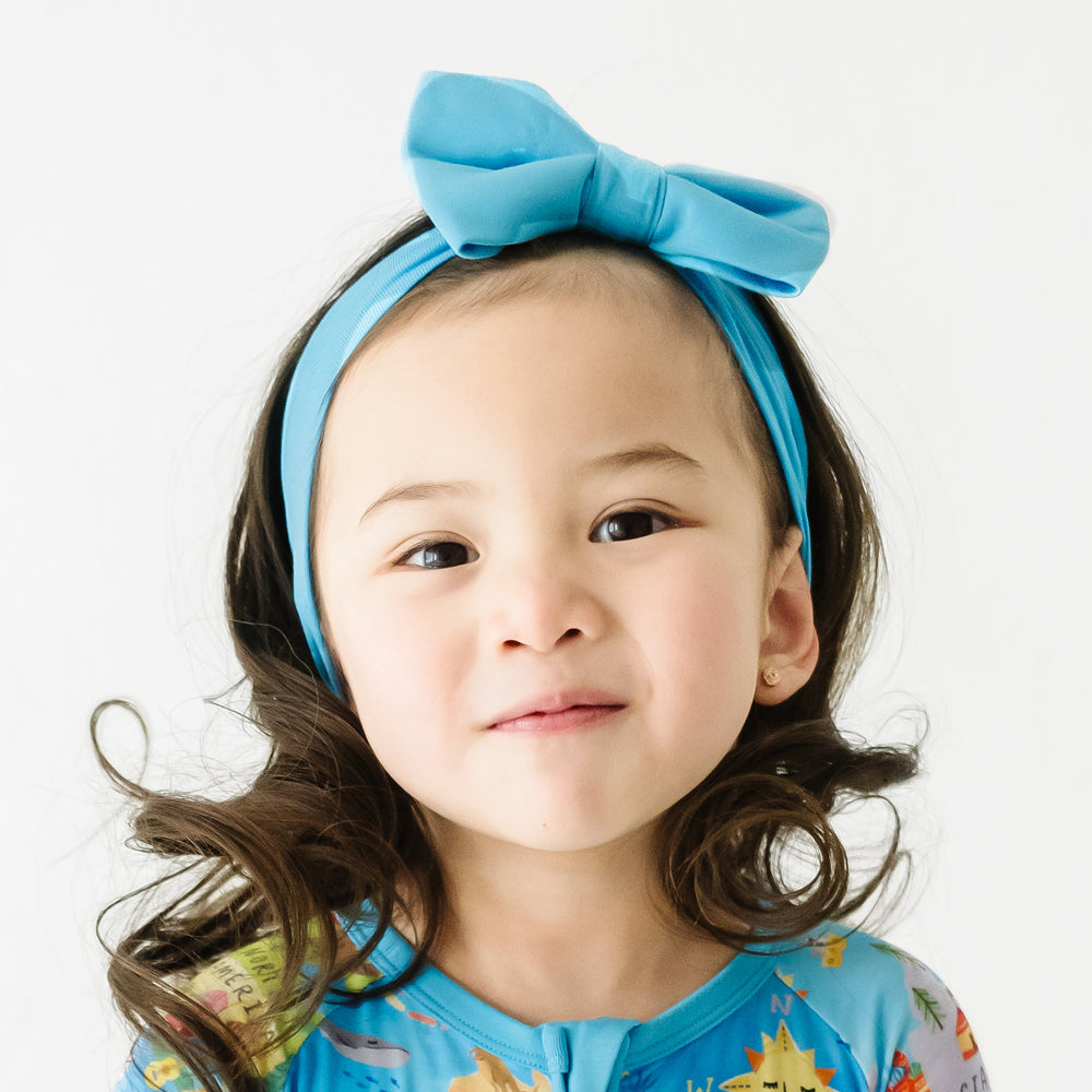 Alternate close up image of a child wearing an Ocean Blue luxe bow headband