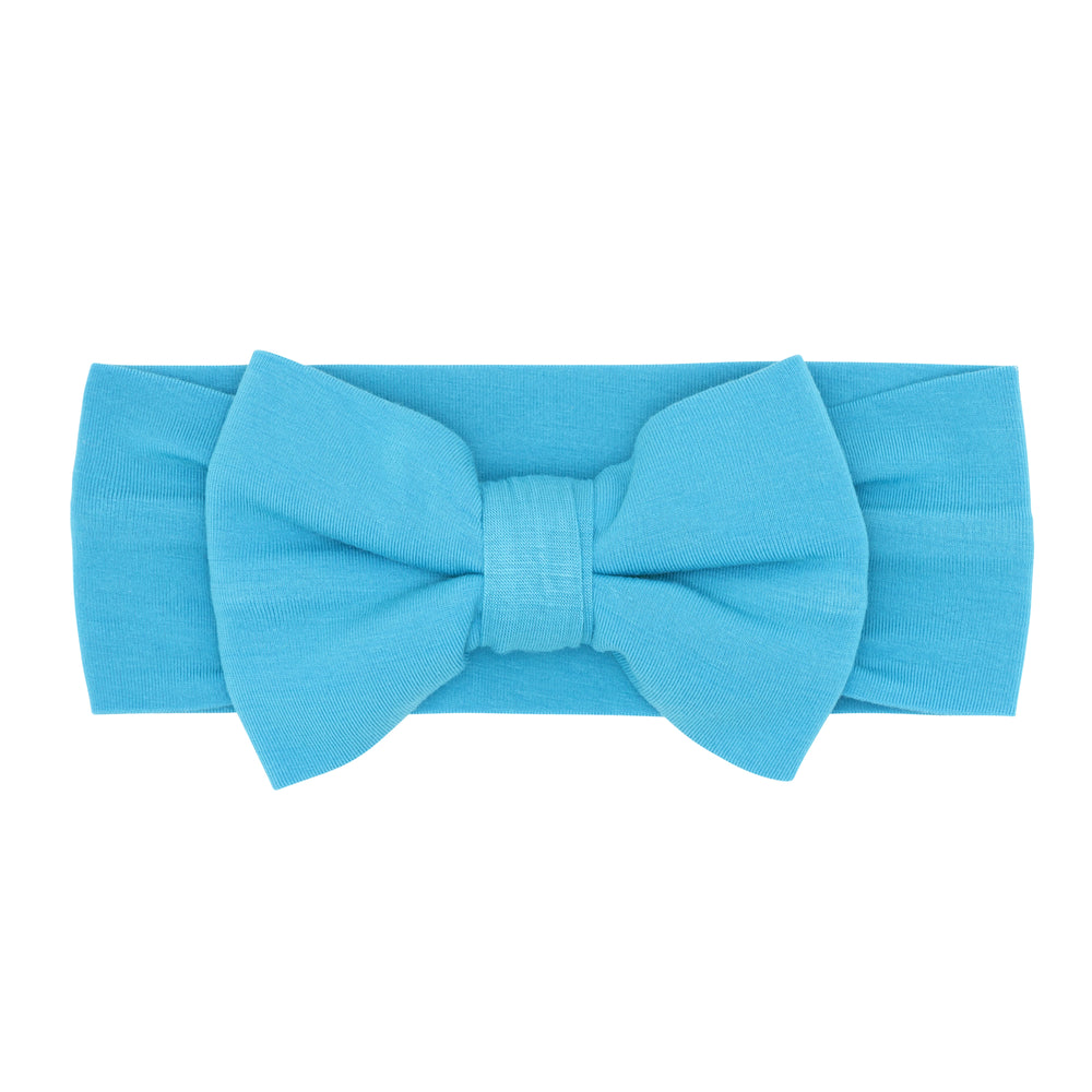 Flat lay image of an Ocean Blue luxe bow headband