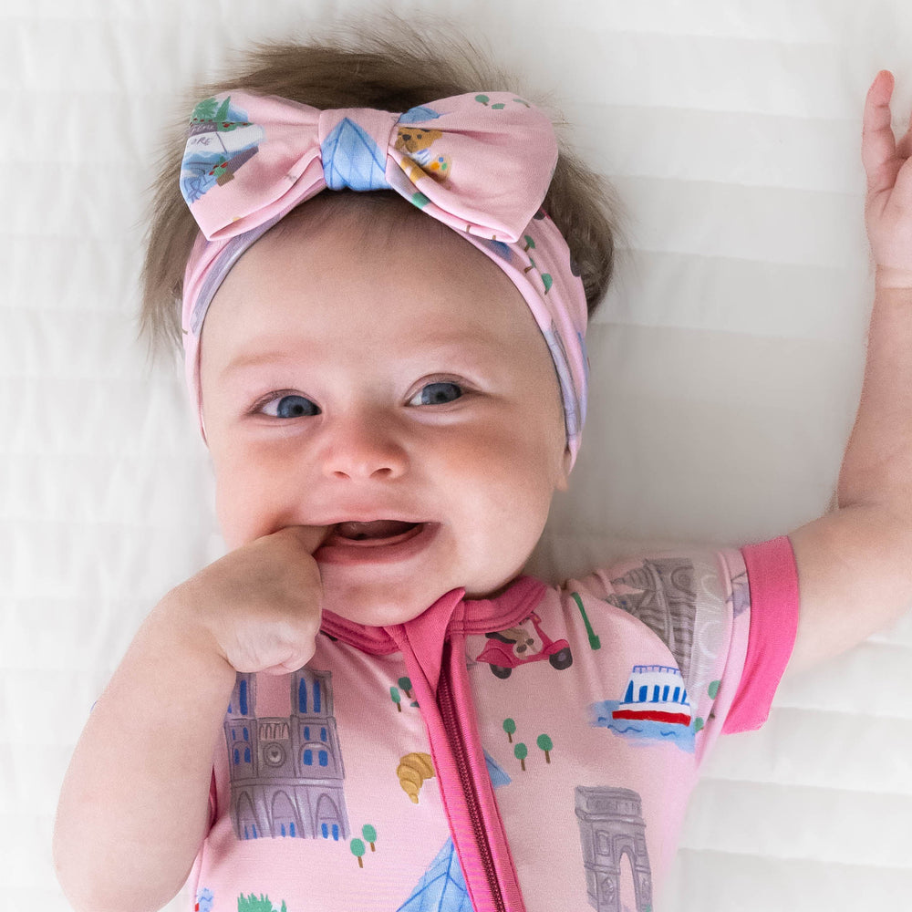 Top view image of baby wearing the Pink Weekend in Paris Luxe Bow Headband