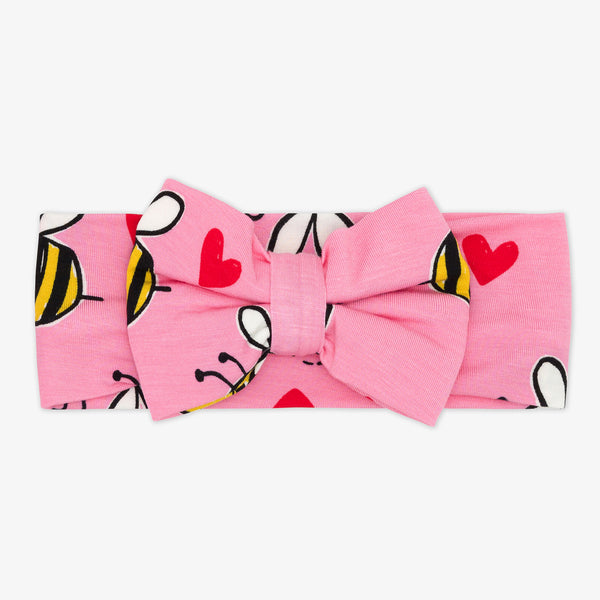 Flat lay image of a Pink Bee Mine luxe bow headband