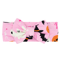 Flat lay image of the Pink Glowing Ghouls Luxe Bow Headband