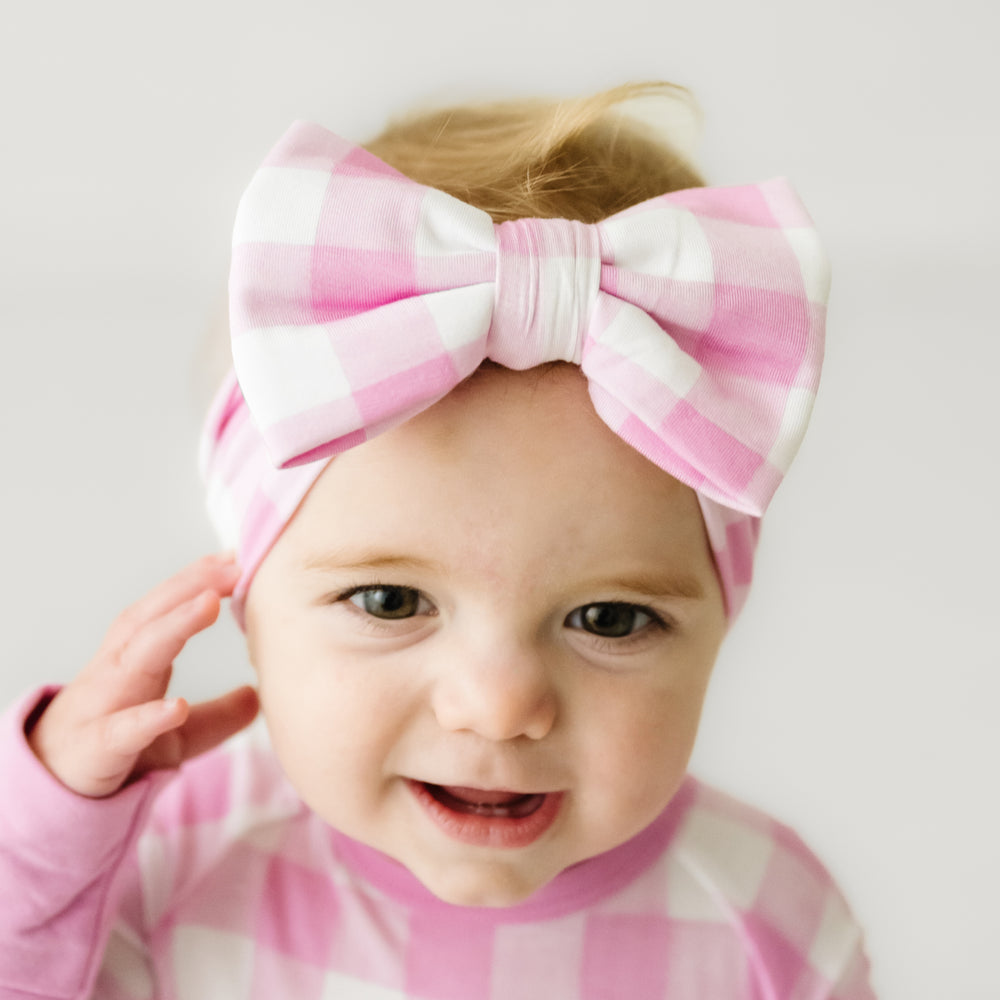 Click to see full screen - alternate close up image of a child wearing a Pink Gingham luxe bow headband