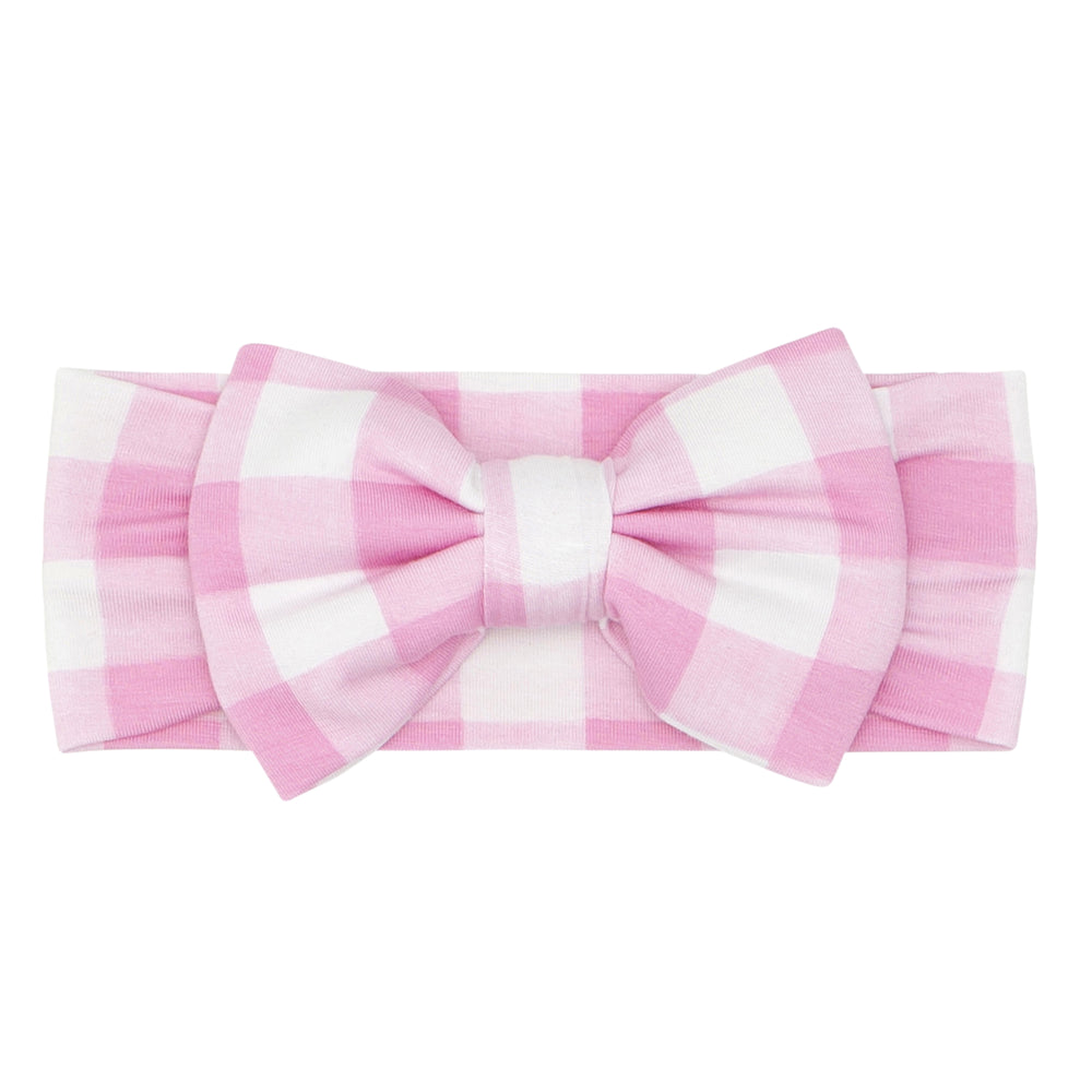 Click to see full screen - Flat lay image of a pink gingham luxe bow headband in size newborn to age four