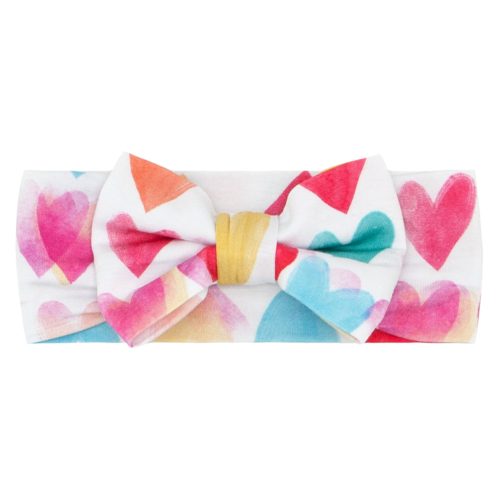 Click to see full screen - Flat lay image of a Watercolor Love luxe bow headband