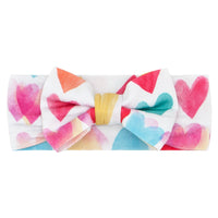 Flat lay image of a Watercolor Love luxe bow headband