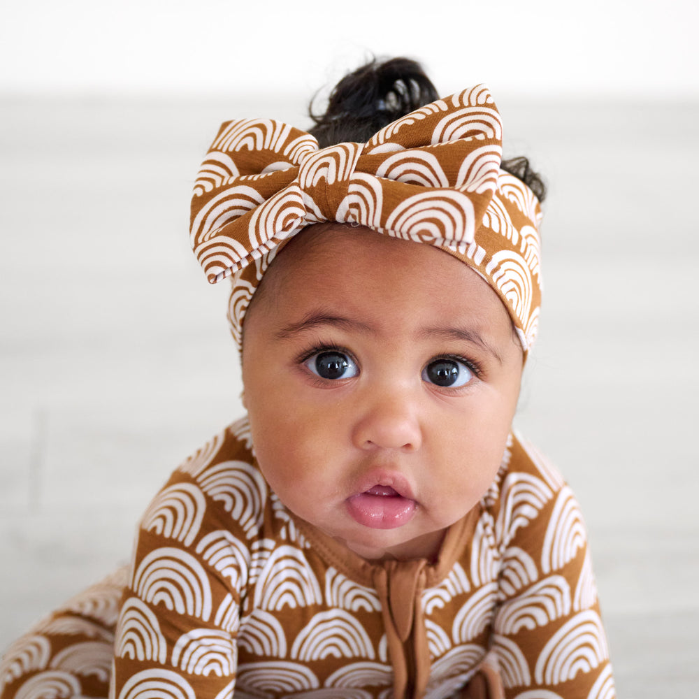 baby looking up wearing the rust rainbows luxe bow