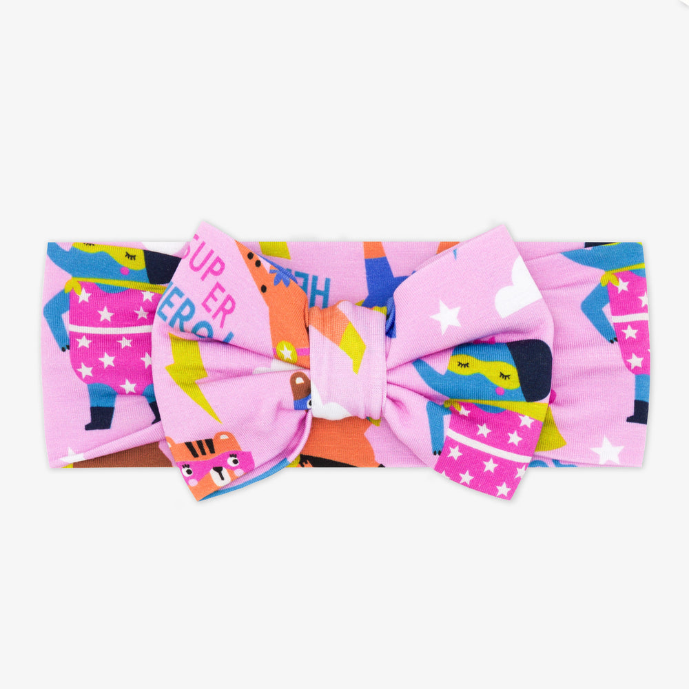 Flat lay of pink Sleepy Heroes luxe bow headband