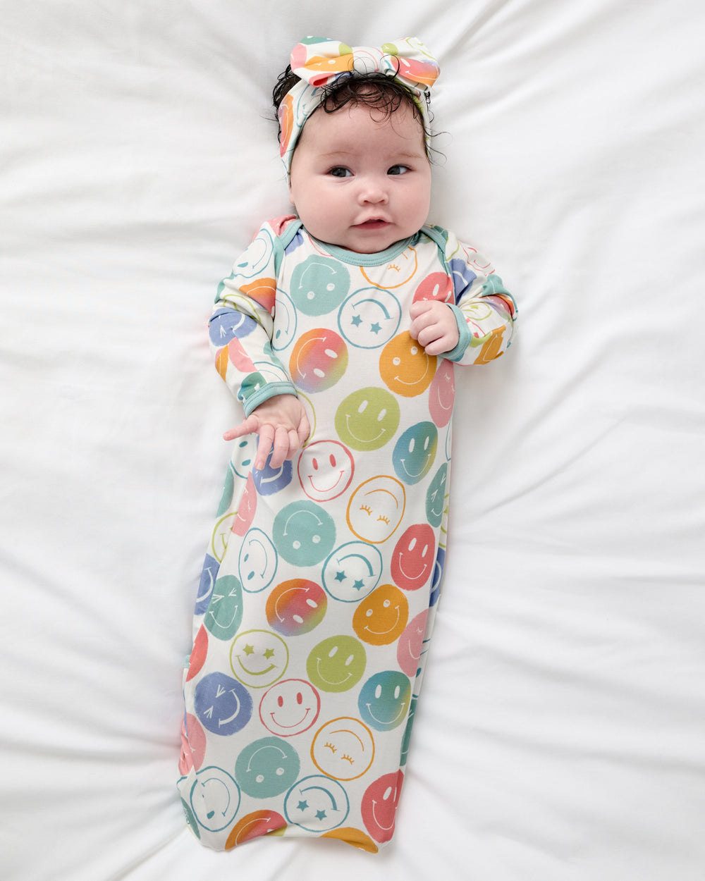 Aerial view of newborn in the Positive Vibes Infant Gown and Bow