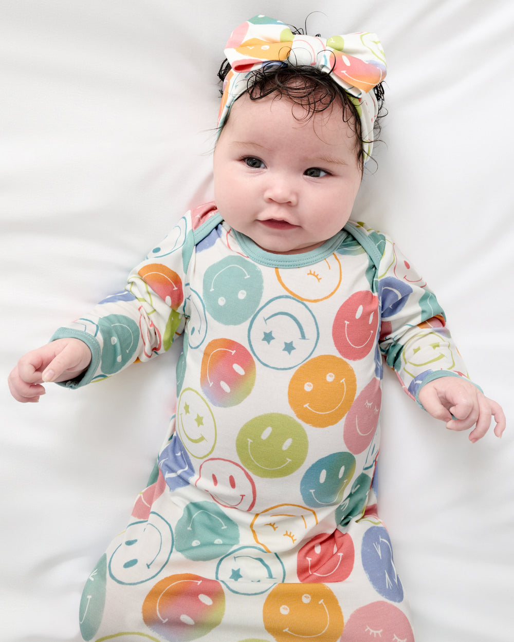 Close up aerial view of baby in the Positive Vibes Infant Gown and Bow