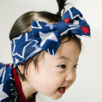 Alternate close up image of a child wearing a Star Spangled luxe bow headband