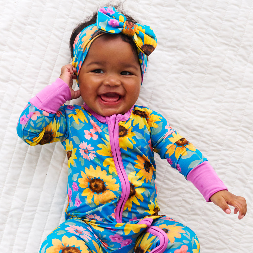 Top view image of baby wearing the Sunflower Fields Luxe Bow Headband and Sunflower Fields Zippy