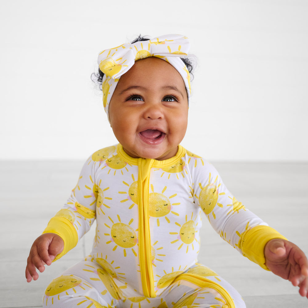 baby laughing wearing sunshine luxe bow headband