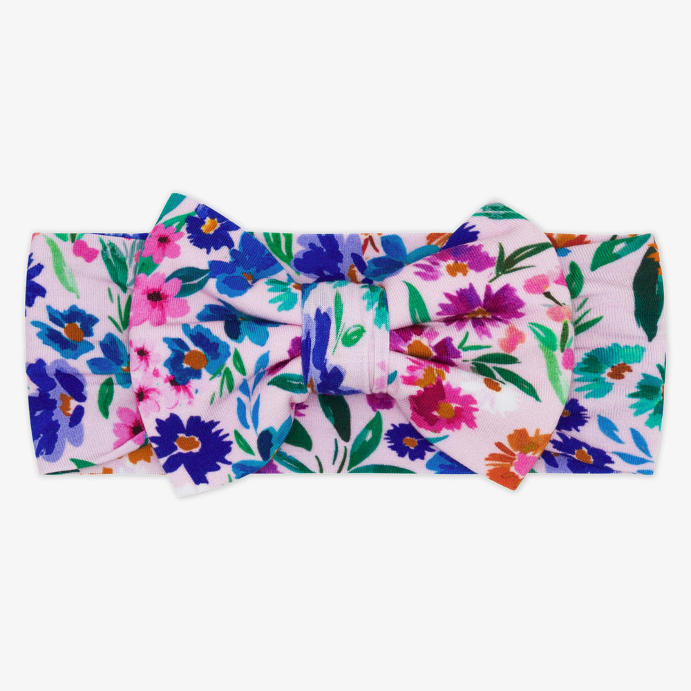 Flat lay image of a Sweet Pea Floral luxe bow headband