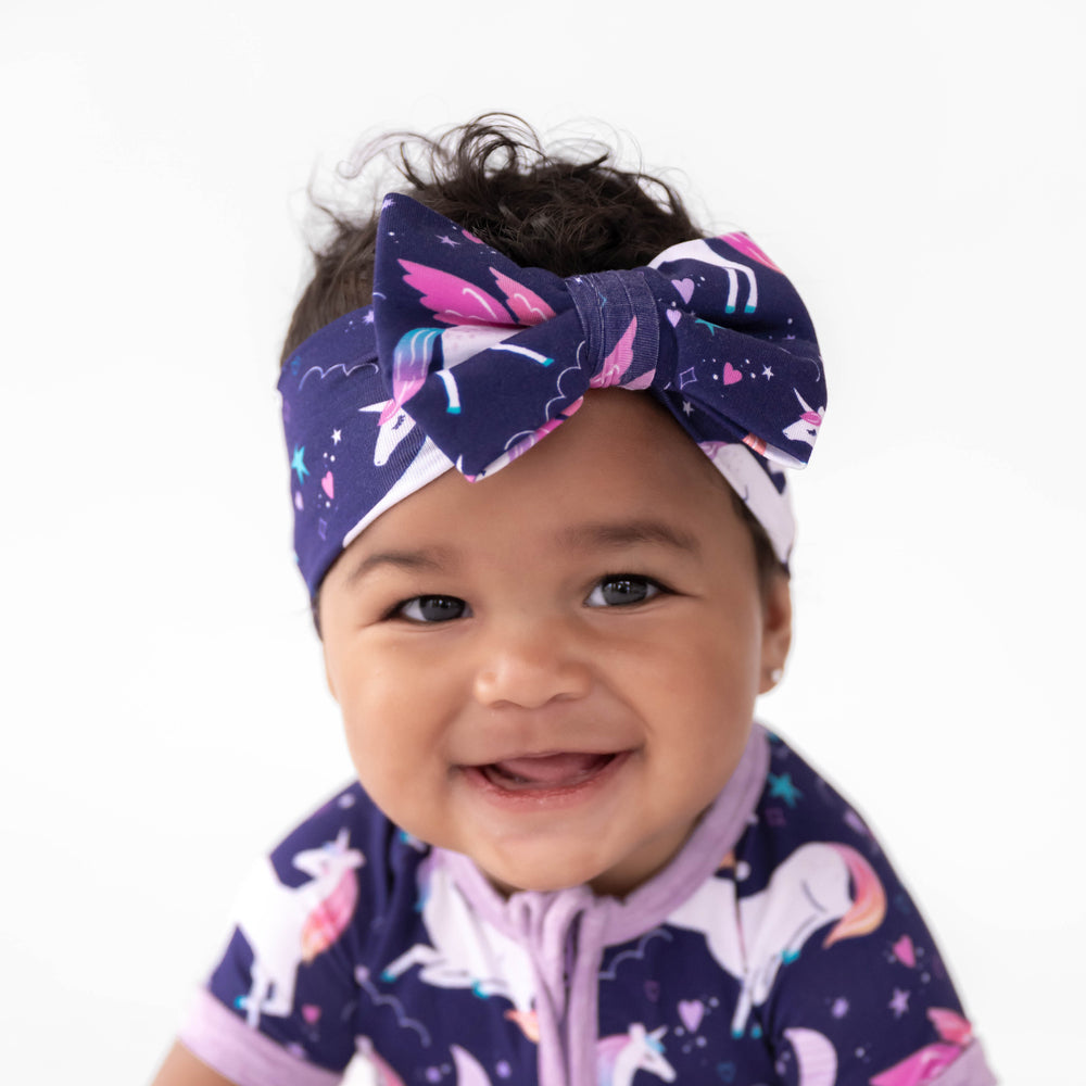 Baby smiling while wearing the Magical Skies Luxe Bow Headband
