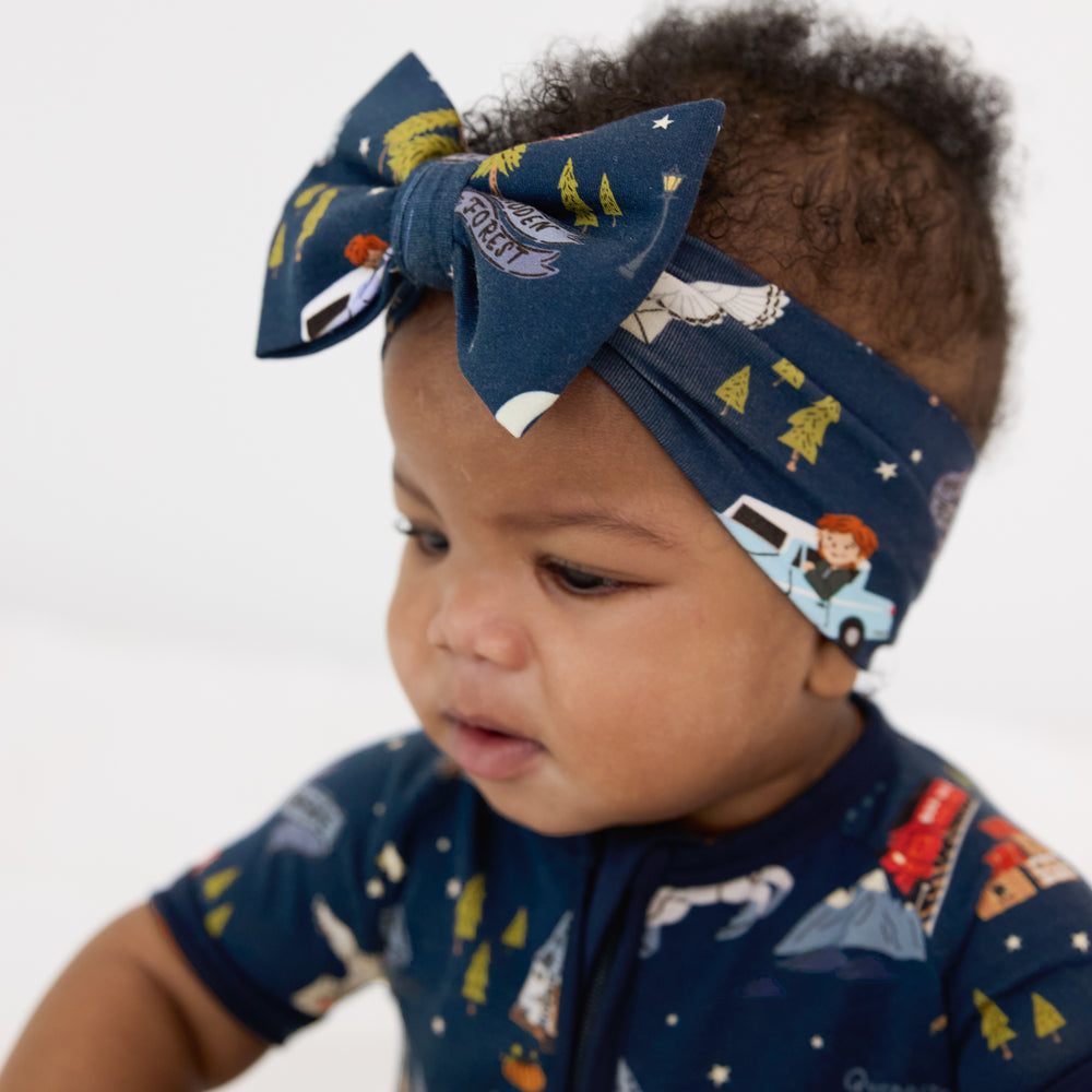 Close up image of a child wearing an Evening at Hogwarts luxe bow headband