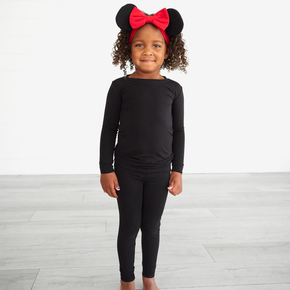 Child posing wearing a Minnie Mouse Ear Luxe bow Headband size 4-8