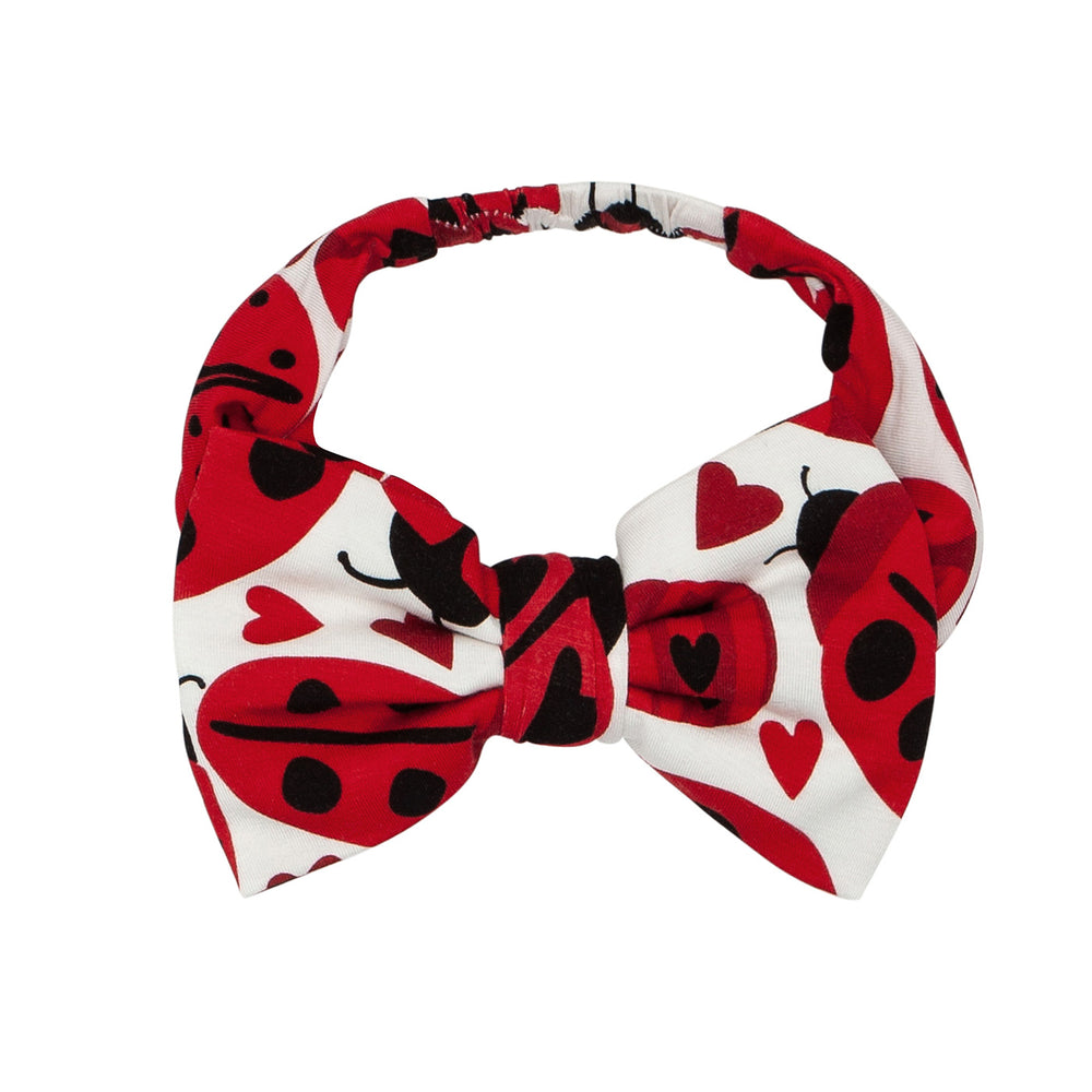 Click to see full screen - Alternate flat lay image of a Love Bug luxe bow headband