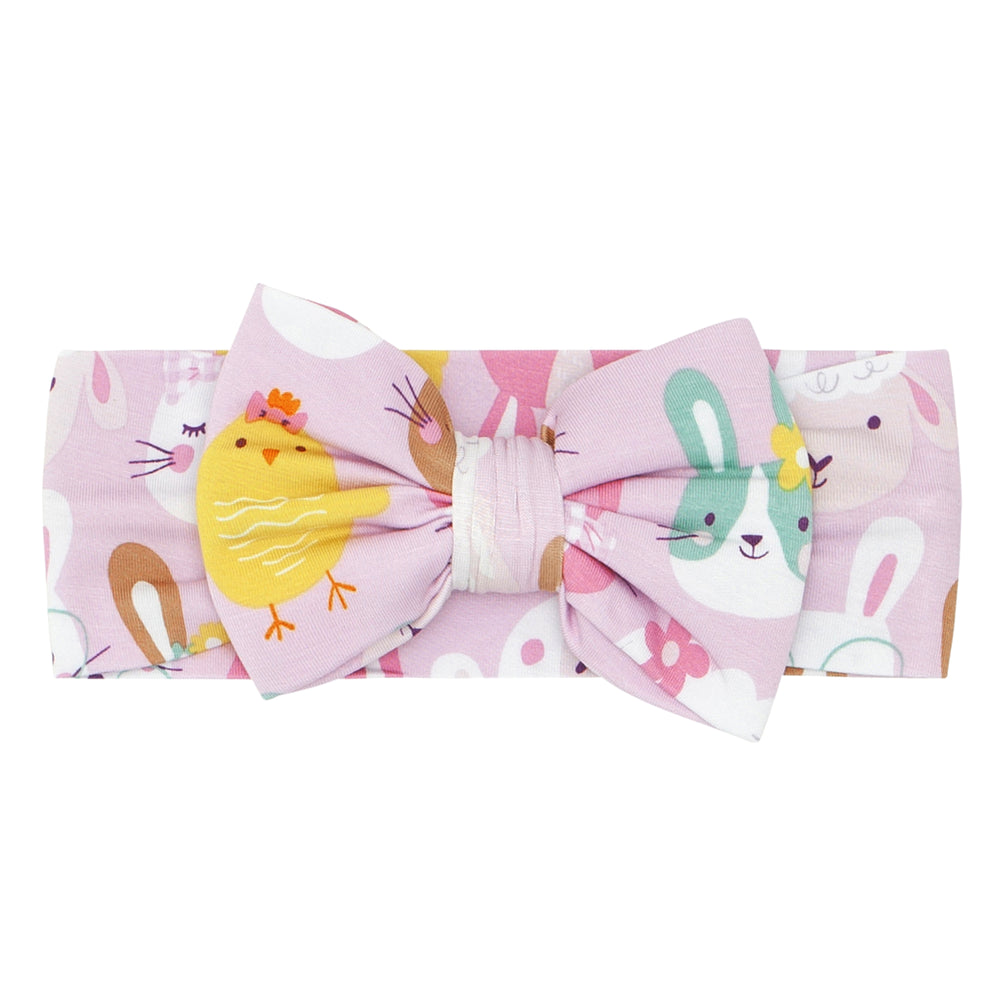 Click to see full screen - Flat lay image of a Pink Pastel. Parade luxe bow headband size newborn to age four