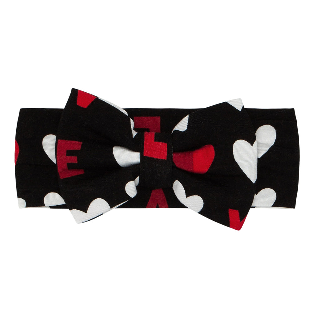 Click to see full screen - Flat lay image of a Black XOXO luxe bow headband in size newborn to age 3