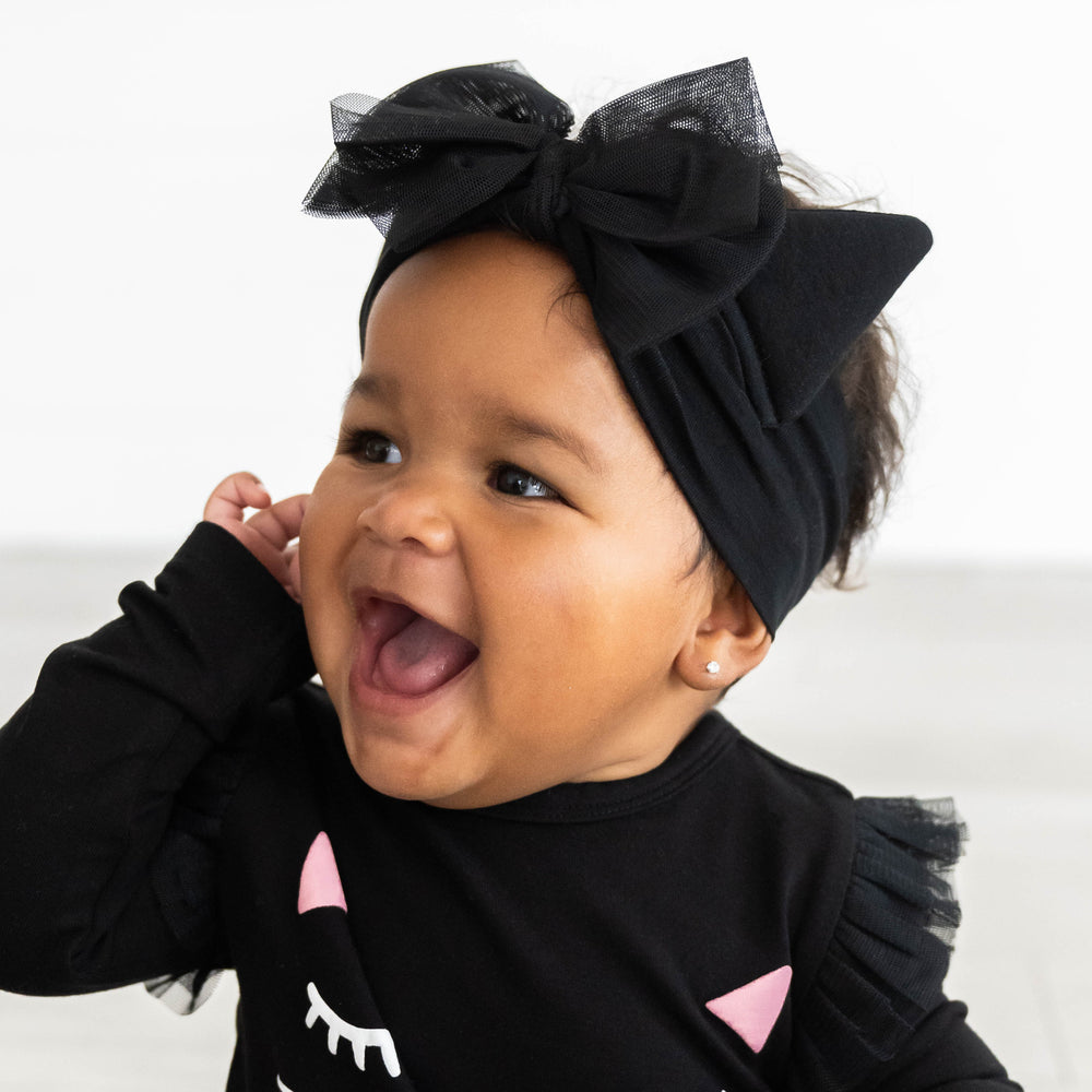 Side view image of baby wearing the Cat Ears Luxe Bow Headband