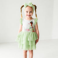 Child wearing a Green tulle luxe bow headband and matching dress