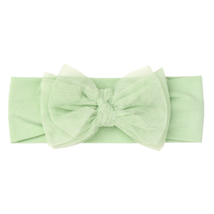Flat lay image of a Green tulle luxe bow headband